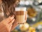 Closeup on young woman with candy and latte macchiato