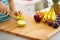 Closeup on young woman cutting apple