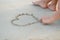 Closeup on young woman drawing on sand