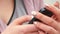 Closeup of young woman hands with smartphone.