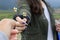 Closeup of young woman holding and giving tiny flowers plant in hand.