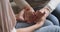 Closeup young woman holding wrinkled hands of elderly retired mother.