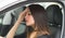 Closeup young woman sitting in car interacting tired using body language, as seen from outside drivers window, female