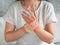 Closeup young woman sitting on sofa holds her wrist. hand injury