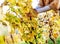 Closeup on young woman in vineyard caring for bushes