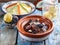 Closeview of tajine of beef with prunes and almonds. In tradiotional Moroccan dish.
