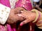 Closup of Indian Young adult male groom and female bride holding hands