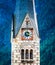 Closup view of protestant church`s clock on high tower in Hallstatt, Austria