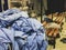 A clothes basket overflowing with surgical scrubs in the changing room of a hospital in the United Kingdom - untidy environment of