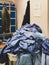 A clothes basket overflowing with surgical scrubs in the changing room of a hospital in the United Kingdom - untidy environment of