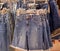 Clothes on hangers in store. Womens denim blue shorts hang on clothing rack. Shopping time concept