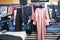 Clothes hanging on the hangers for repair in a traditional tailor shop