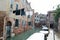 Clothes hung to dry over calm canal in Venice, Italy