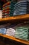 Clothes are neatly stacked on the shelves in the store. Shirts, jeans