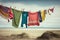 a clothesline with clothes fluttering in the wind on a beach