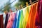 clothesline with rainbow of colorful clothes drying in the breeze