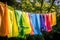 clothesline with rainbow of colorful clothes drying in the breeze