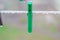Clothespin of green color for linen. Clothespin on a rope for things. Drops of rain, sediment on pvc clothesline. Clothespin macro