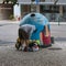 Clothing Bank: Boy Recycling Clothes in Colorful Container