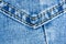 clothing items blue stonewashed faded jeans cotton fabric texture with seams, clasps, buttons and rivets, macro, close-up