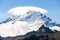 Cloud cap weather phenomenon hovers above the peak of Mount Baker