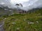 Cloud-Cloaked Retreat: Alpine Hut Enveloped in Ethereal Mountain Mystique