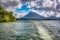 Cloud-covered Arenal Volcano in Costa Rica\\\'s Arenal National Park, as seen from a boat on Lake Arenal