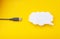 Cloud for data storage cut from paper on a yellow background and cable usb, close-up, data storage on the Internet