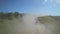 Cloud of dust over a rural dirt road