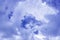 Cloud formation, background with blue sky and cumulus clouds. Upper atmosphere, troposphere. The beginning of thunderstorm.