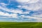 Cloud formations over a green field