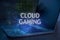 Cloud gaming inscription against laptop and code background