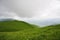 Cloud hanging over hill