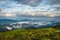 Cloud layers on mountain horizon with green grass