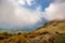 Cloud obscured views of the bays of Lake Wanaka and the snow capped Southern Alps from the Roys Peak mountain track