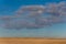 Cloud over an empty agricultural field