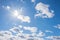 Cloud scape background with bright sun and fluffy cumulus