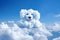 Cloud in the shape of an adorable puppy face against a clear blue sky. The image evokes a sense of playfulness and joy, as if the