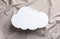 Cloud shaped child`s night lamp on beige fabric, top view