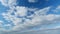 Cloud stratocumulus nature background. Blue sky with clouds and sun. Nature background of airy cloudscape. Timelapse.