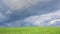 Cloud time lapse above green agriculture field. Simple nature, climate background