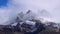 Cloud timelapse of snowy mountain peak in the French Alps