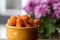 Cloudberry Rubus chamaemorus close up in orange bowl on wooden table,autumn harvest in norwegian mountains near Hemsedal