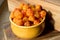 Cloudberry Rubus chamaemorus close up in orange bowl on wooden table,harvest in norwegian mountains near Hemsedal ski