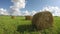 Clouded summer sky over country field with haystacks and clouds. Timelapse 4K