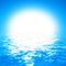 Cloudless blue sky background with bright sun and crystal clear water