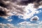 Clouds against a background of sunrays in a blue sky