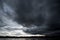 Clouds with background,sunlight through very dark clouds background of dark storm cloud