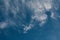 Clouds and a blue sky with a bunch of flying birds