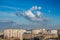 Clouds on blue sky in cityscape.